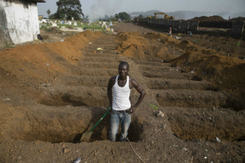 A man digs a grave for Ebola victims during the outbreak in West Africa. The 2014-1026 outbreak was the most serious in history and its global spread was only prevented by swift action by international health officials.