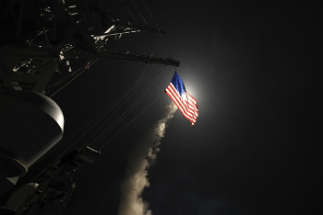 A cruise missile is fired from a U.S. Navy ship during a previous strike on Syrian facilities. Another such strike appears imminent.
