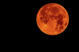 During a lunar eclipse, the moon can turn orange to blood red or black.
