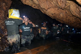 Rescuers work to drain water and make the cave more accessible in an effort to rescue the soccer team.