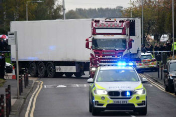 Police officers drive away a lorry in which was discovered 39 dead bodies at Waterglade Industrial Park in Grays east of London Oct 23 2019