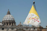 Image of View of St. Peters Basilica and Vatican City flag
