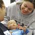 Image of STUDENTS TEND TO DOLL BABIES – Junior Jazleen Rosado, left, and senior Marilin Torres tend to their 
