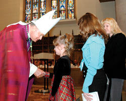Image of BISHOP CONGRATULATES CATECHUMEN – Greensburg Bishop Lawrence E. Brandt shakes hands with catechumen Tabitha Morris, 7, March 5 at Blessed Sacrament Cathedral in Greensburg, Pa. Behind her is her sister Summer, 12, also a catechumen, and their sponsor Madeline Weigner. (The Catholic Accent photo)

