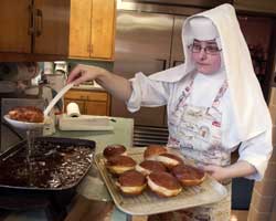 Image of NUN FILLS PRE-LENTEN PASTRY – Sister Patrycja Bryniarska fills paczki dough with jelly at the Albertine Home in Hammond, Ind., Feb. 23. The traditional Polish pastries are said to have come about as a way to do away with rich ingredients that could not be consumed during Lent. (CNS photo/Northwest Indiana Catholic) 