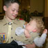 Image of PHILADELPHIA TEEN HOLDS BABY BROTHER SEVERAL MONTHS AFTER SAVING HIS LIFE
Joseph McCabe cradles his brother Riley, now 18 months old, after Riley fell asleep at St. Cecilia Church in Philadelphia. Joseph will always remember July 20, 2005, as the day he saved the life of Riley, then 9 months old. The 13-year-old Boy Scout per formed the Heimlich maneuver on the infant after he swallowed a piece of tape and began choking. (CNS/Catholic Standard & Times)