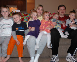 Image of INDIANAPOLIS COUPLE AT HOME WITH QUADRUPLETS PLUS TWO
Rick and Ellen Taylor of Indianapolis pose for a photo with their 2-year-old quadruplets and two older sons. The children from left are Zachary, 7; Jacob, 4; Allison, Hannah, Abigail and Benjamin. Ellen teaches a first-grade class at Holy Name School in Beech Grove, Ind. (CNS/The Criterion)
