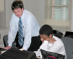 Image of STUDENTS PREPARE TO PRESENT BUSINESS PLAN – Aspiring entrepreneurs Joseph Heck, left, and Jamal Calhoon prepare to present their plan to a panel of judges at a summer program at St. Louis University (SLU) for high-school students interested in starting a business. The program, sponsored by the Smurfit-Stone Center for Entrepreneurship at the university's business school, was called 