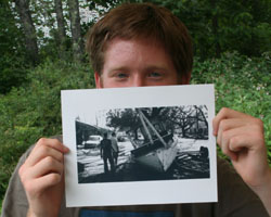 Image of VOLUNTEER GRAD TO RETURN TO NEW ORLEANS: Patrick Semansky shows a photo of a boat left in the streets of New Orleans after Hurricane Katrina and the flooding caused by the break in the levee. (Photo/Mary Carty)