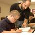 Image of TEACHER WORKS WITH STUDENT WHO HAS DOWN SYNDROME - Mike Gittings, a geometry teacher at Mount St. Joseph High School in Baltimore, Md., helps Ben Stevick with a geometry problem in late September. Ben, a 17-year-old sophomore, is the first student with Down syndrome to enroll in a Catholic high school in the Archdiocese of Baltimore. (CNS/Catholic Review)