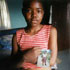 Image of THE CHILDREN LEFT BEHIND: Sizakele Keswa, 13, South Africa, holds the only picture of her deceased mother. This photograph is a part of a multimedia exhibit featuring creative works that capture life though the eyes of orphans and other children left vulnerable by HIV/AIDS. A glimpse of the exhibit and tour schedule can be found at
<a href=http://www.the children left behind.org/index.cfm target=_blank>www.thechildrenleft behind.org/index.cfm</a>
(Photo/CRS)
 