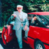 Image of CENTENARIAN POSES IN FRONT OF CAR IN CONNECTICUT PARISH PARKING LOT - Mike Mele, who celebrated his 100th birthday Dec. 16, poses by his sporty, candy-apple-red Ford Probe in the parking lot of his parish, Our Lady of Mount Carmel in Hamden, Conn. Mele is a catechist, lector, altar server and extraordinary minister of holy Communion at his church. (CNS photo/Mary Chalupsky, Catholic Transcript) 