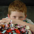 Image of THIRD-GRADER POSES WITH BLANKETS FOR CHARITIES PROGRAM – Connor McClain, who enlisted the third-graders at Good Shepherd School in Shawnee, Kan., to make baby blankets for a hospice program and for Catholic Charities' mother-baby program, poses with some of the blankets in mid-April. (CNS/The Leaven)