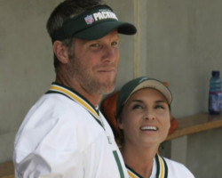 Image of GREAT QB, GREAT WIFE - Brett and Deanna Favre stand in the dugout at their charity softball game.