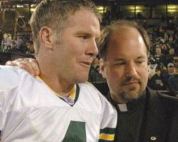 Image of TOP TEN - Brett Favre, quarterback of the Green Bay Packers, exits the field with the team chaplain, Norbertine Father James T. Baraniak, after the Packers' 41-7 victory over the Raiders in Oakland, Calif., Dec. 22. Favre is one of Catholic Online's Top Ten Catholic Heroes of the Super Bowl. (CNS photo by Jim Biever, Green Bay Packers)