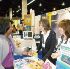 Image of VBS PROPONENTS - Dione Grillo (left), director of children’s ministry at St. John Eudes in Chatsworth, chats March 2 with Susan Lawson (middle) and Melissa Kaiser (right), founders of “Growing with the Saints” Catholic Vacation-Bible School programs at the recent Religious Education Congress in Anaheim. (Paula Doyle)