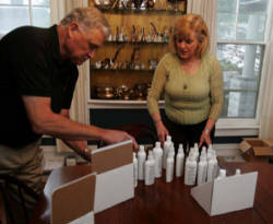 Image of Buz and Gay Fishter package their Parsley Hollow All Natural Pet Products in hte dining room of their Wooster home. (Lew Stamp/Akron Beacon Journal)