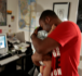 Image of Adell Hendon hugs his son Noah, 4 months-old, on Tuesday, June 3, 2008, in Parkville, Missouri. Hendon has chosen to work from home so that he can be with Noah as much as possible. (Shane Keyser/Kansas City Star/MCT)