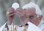 Image of Pope Benedict XVI elevates the consecrated host during the divine liturgy.