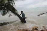Image of A South Pacific islander watches as a 