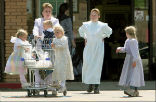 Image of Polygamy isn't all sister wives and fun. A woman in Hilldale, Utah, where polygamy is ubiquitous, exits a store with several children. 