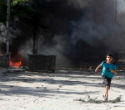 Image of A child flees violence in Syria. In that country's civil war, children are considered viable targets. 