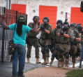 Image of Police in Ferguson move detain a protester. 
