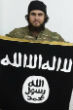 Image of Mounir Raad poses with the flag of the Islamic State. He tweeted a chilling picture of children armed with AK-47 assault rifles. 