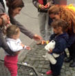 Image of German child gives a refugee candy.
