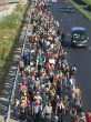 Image of Massive amounts of migrants begin making journey on foot.