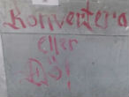 Image of The graffiti scrawled on a restaurant clearly warns Christians to convert or they will be killed.