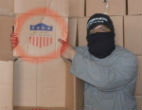 Image of A fighter poses with what is reported to be to be U.S. supplies. 