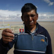 Image of A fisherman displays his license. Without any water or fish, his livelihood has evaporated. Bolivia has declared a national disaster.