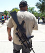 Image of A man open carries a firearm on a college campus. Perhaps seeing firearms more often will convince people that firearms are also safe?