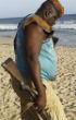 Image of A man stands over the body of one of the victims of the weekend assault. 