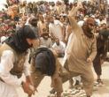 Image of Fanatic men enthusiastically participate in the execution. 