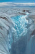Image of Researchers survey melting on Greenland. 