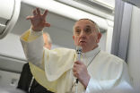 Image of Pope Francis takes questions from reporters on his flight home to Rome.