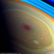 Image of Saturn has a violent storm swirling at the north pole. 
