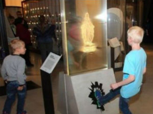 Image of The exhibit, which attracts children, encourages people to desecrate a statue of the Virgin Mary.