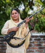 Image of Shahana Begum protects women with her shotgun and as a result, violence against women has dropped dramatically. 