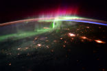 Image of The aurora are caused by charged particles that are drawn into the atmosphere by Earth's magnetic field where they strike gas molecules, causing them to glow. 