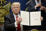 Image of Trump holds his executive order banning immigration for refugees and from seven countries until Homeland Security can revamp vetting procedures.