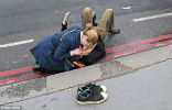 Image of A women comforts a victim who survived the attack with injuries. Several people have serious injuries. 