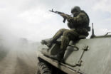 Image of A Russian soldier rides on an armored vehicle in this file image.