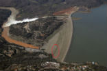Image of The green area on the face of the dam suggests water is seeping though the dam. 