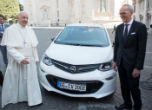 Image of Pope Francis with his new car. The car is part of the plan to make the Vatican the first carbon neutral state. 
