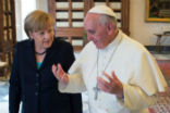 Image of Pope Francis shares a teaching moment with Chancellor Merkel. 