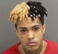 Image of Racist thug, XXXTentacion in his latest mugshot for violent behavior. His video, which shows him lynching a child, has gone viral, earning him a payout from YouTube. 