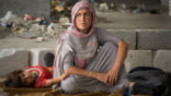 Image of A Yazidi refugee woman with her child. ISIS slaughtered thousands of Yazidi and Christian minorities during their rampage though Syria and Iraq. 